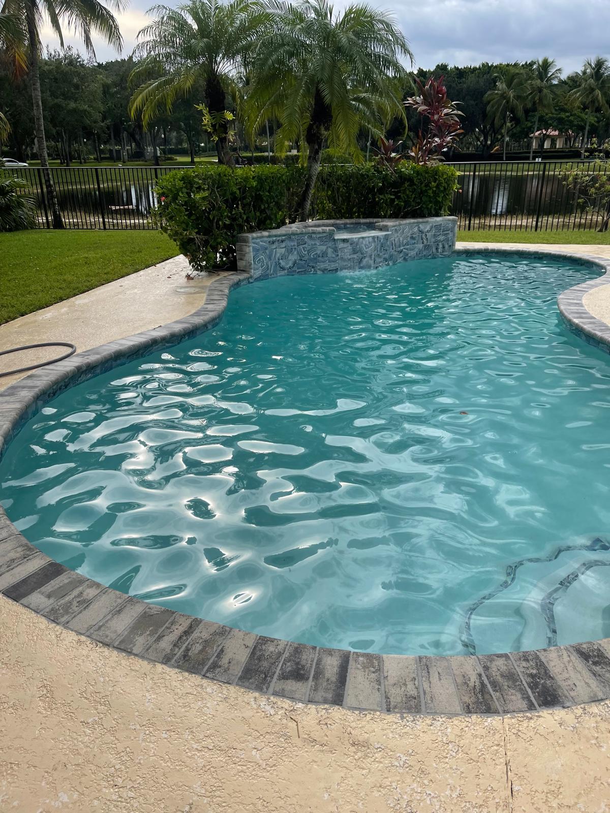 Finished small pool remodel with refreshed tile and coping