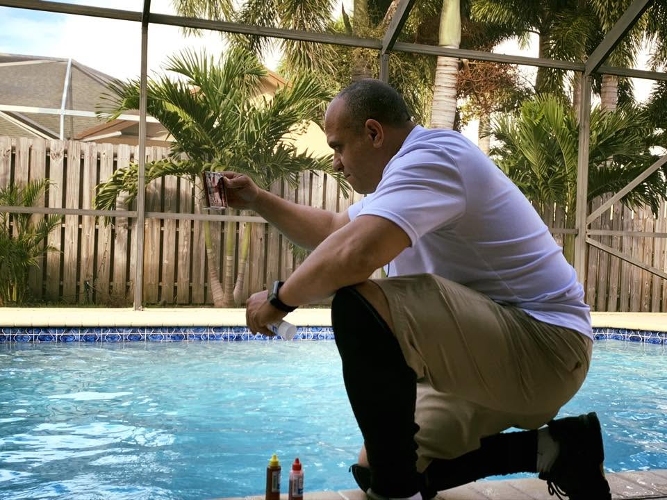 Clean Water Pool Services technician testing pool water